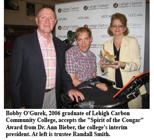 Bobby O'Gurek, 2006 graduate of Lehigh Carbon Community College, accepts the "Spirit of the Cougar" Award from Dr. Ann Bieber, the college's interim president. At left is trustee Randall Smith. Bobby O'Gurek, 2006 graduate of Lehigh Carbon Community College, accepts the "Spirit of the Cougar" Award from Dr. Ann Bieber, the college's interim president. At left is trustee Randall Smith.